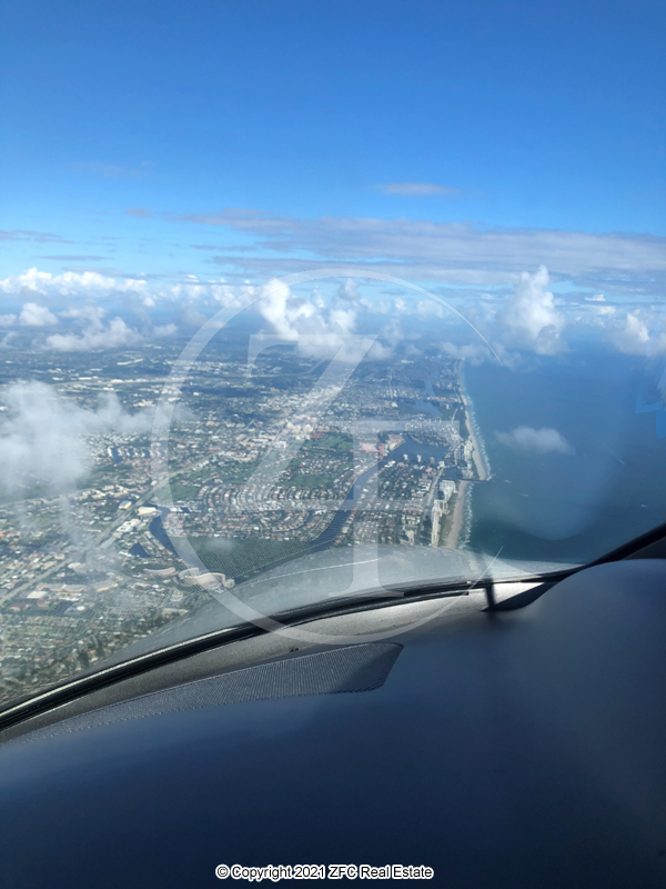 Jet flying over Royal Palm Yacht Club